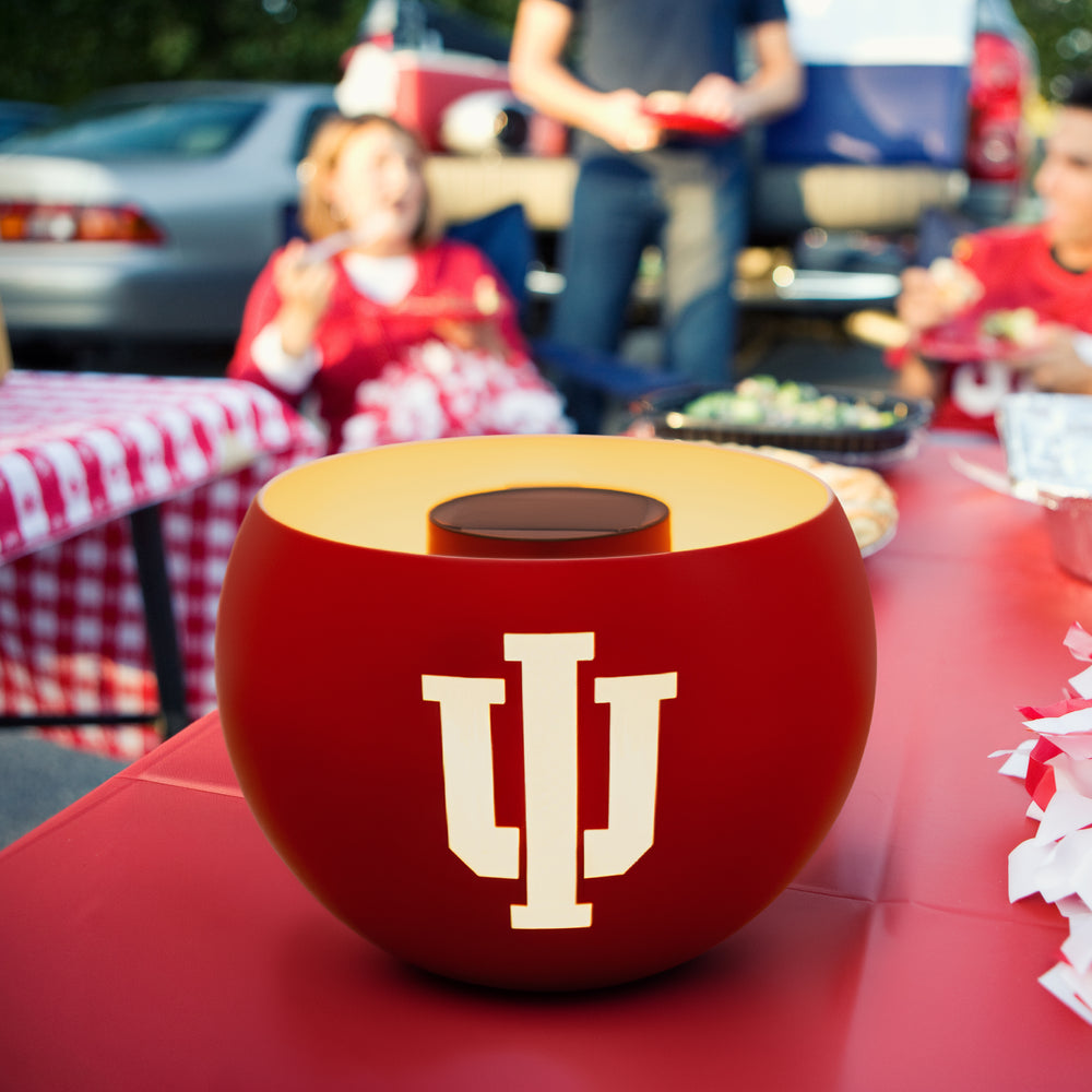 Red bowl with a logo on a table at an outdoor event